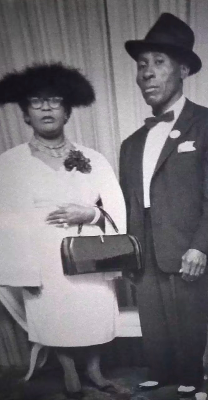 Black-and-white Marshall family portrait of a formally dressed couple standing together